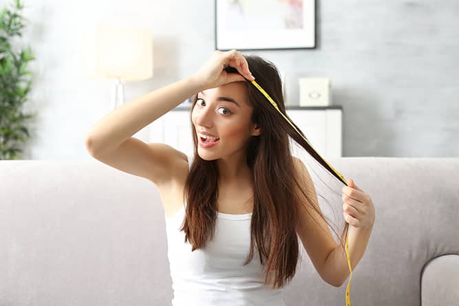 a woman measuring her hair growth