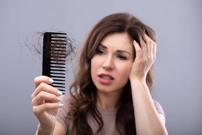a woman stressed over her hair loss