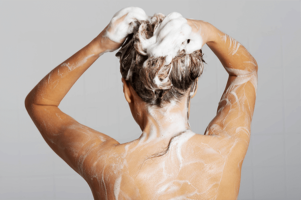 Woman washing her hair with thick lather